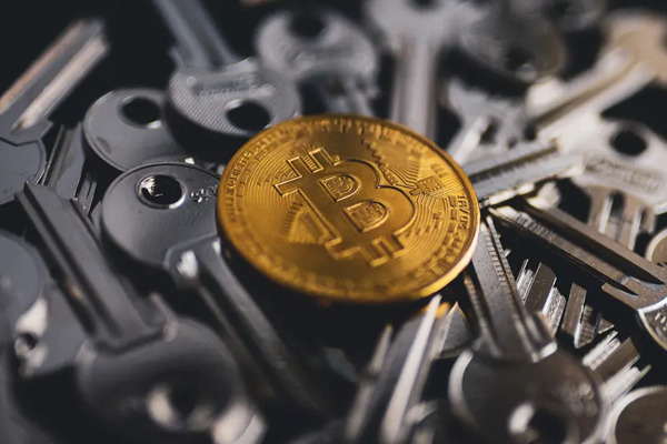 Image of a bitcoin sitting on a pile of keys